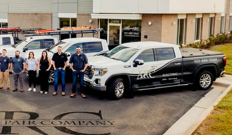 The ARC crew lined up beside an ARC Electric truck outside the shop in Fuquay-Varina