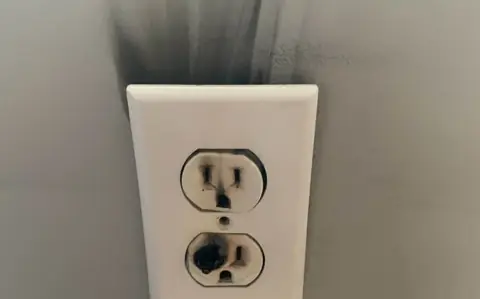 A scorched wall outlet from an electrical fault