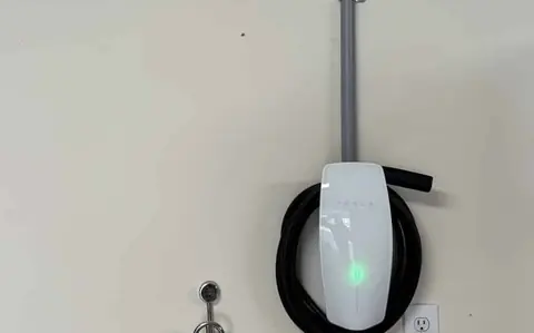 A Tesla Wall Connector ARC installed in a garage