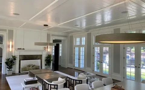 A dining room with new pendant and recessed lighting
